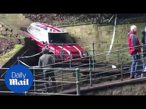 Bizarre footage shows Mini Cooper stuck in a very tight spot – Daily Mail