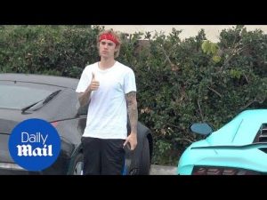 Justin Bieber poses for paparazzi next to his new Lamborghini – Daily Mail