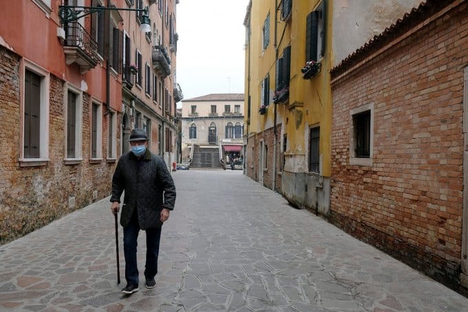 man walking down the road with a mask during corona virus outbreak